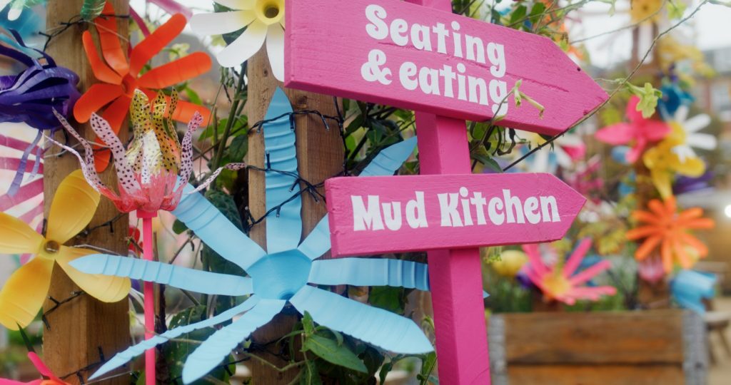 Pink direction sign at Electric Daisy, community garden in Derby.